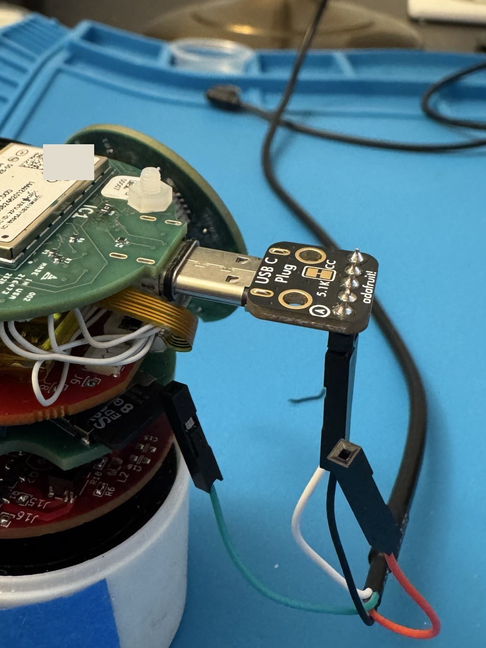USB-C breakout board connected to an open device with its PCBs exposed